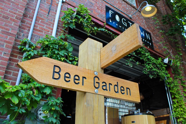 A wooden Beer Garden sign at the brewery entrance