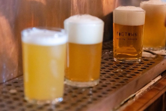 Pints of golden beer on the bar mat
